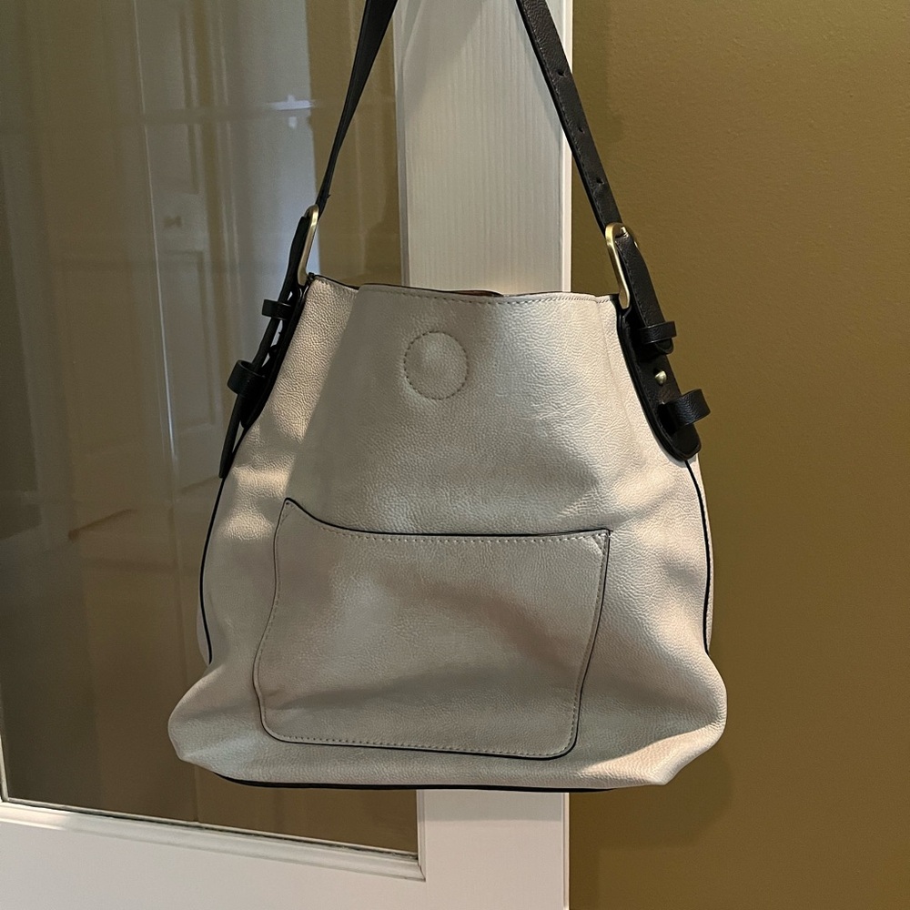 Joy tan/black handbag with smaller black bag inside with its own longer strap.